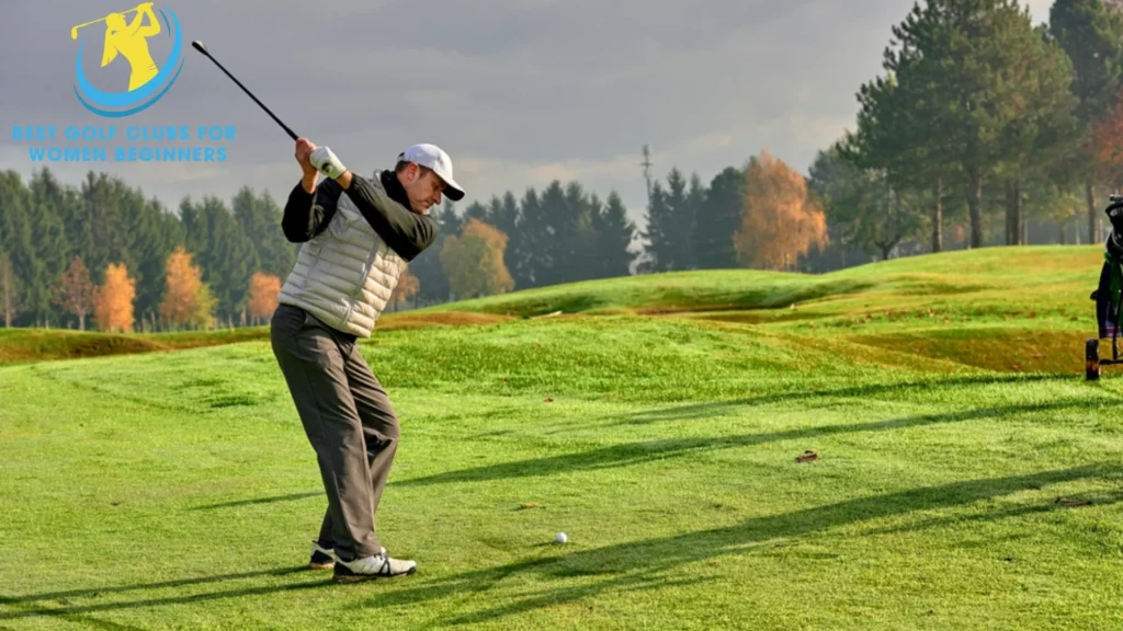 The image shows a male golfer wearing winter shoes and rain gloves